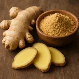 Fresh ginger root and ginger powder in a wooden bowl